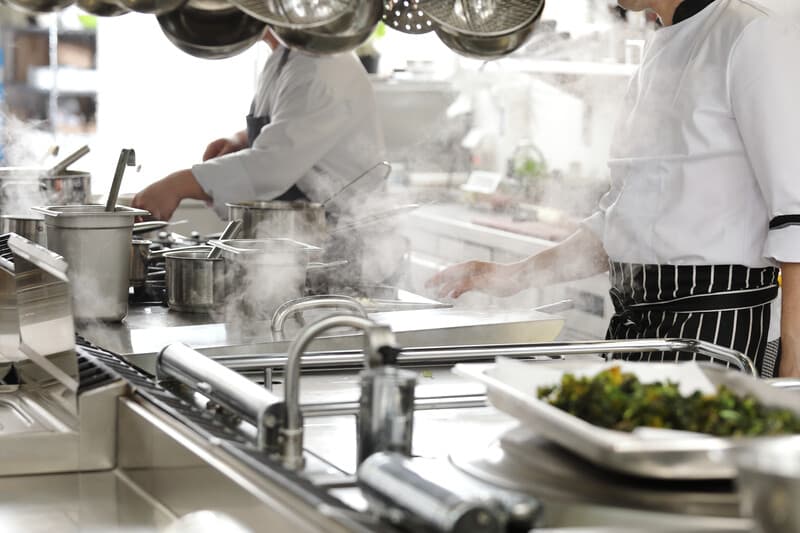 Chefs preparing food in kitchen