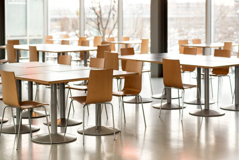 Interior of empty canteen with tables and chairs